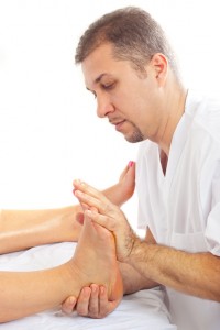 Orthopaed man massaging foot